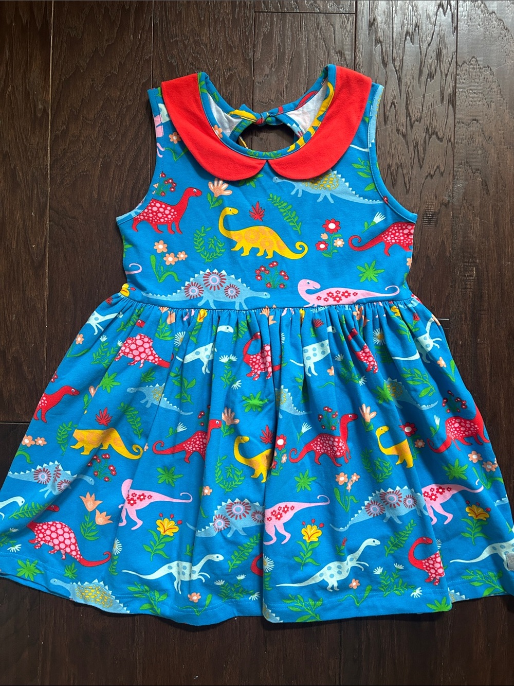 Eleanor Rose Bright Blue Dinosaur Print Girl’s Tunic with Red Peter Pan Collar